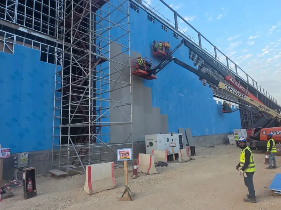 Cement board sheathing installed from boom lifts on the external walls of the data center